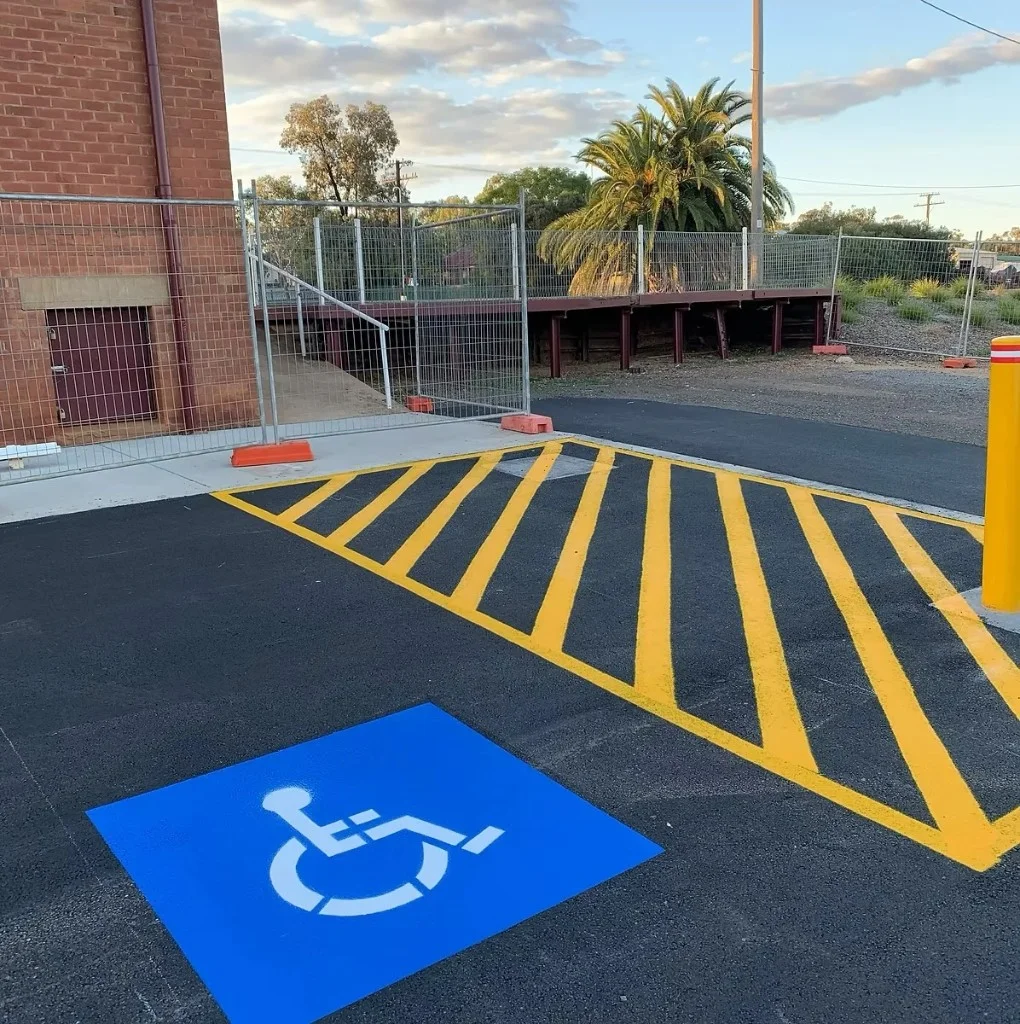 AS 2890.6 compliant disabled parking bays with yellow shared zone hatching and bollard in Condobolin
