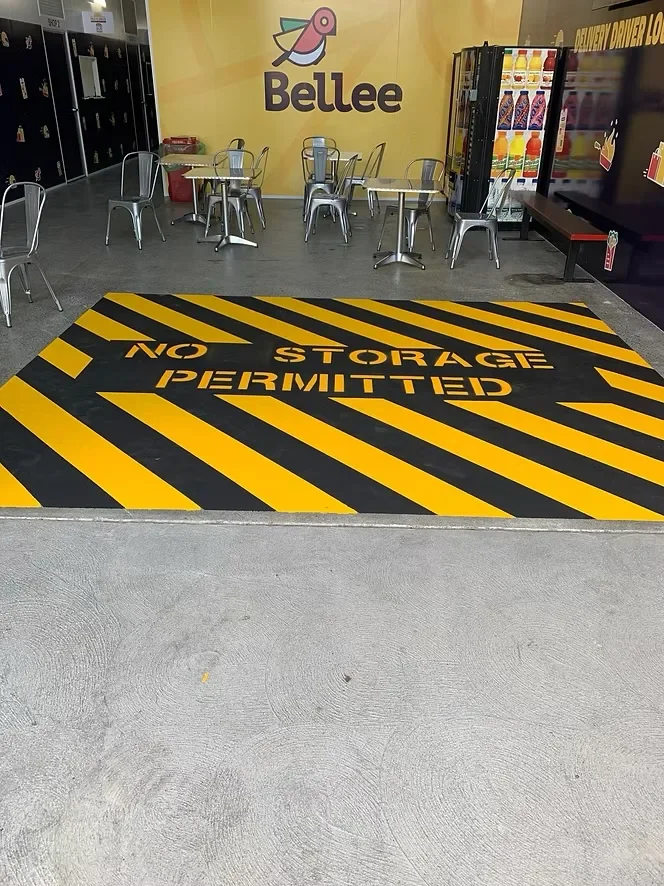 Yellow and black no storage permitted hazard marking on a commercial floor