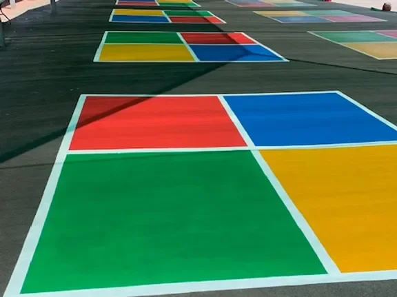 Colourful four-square handball court on a school playground